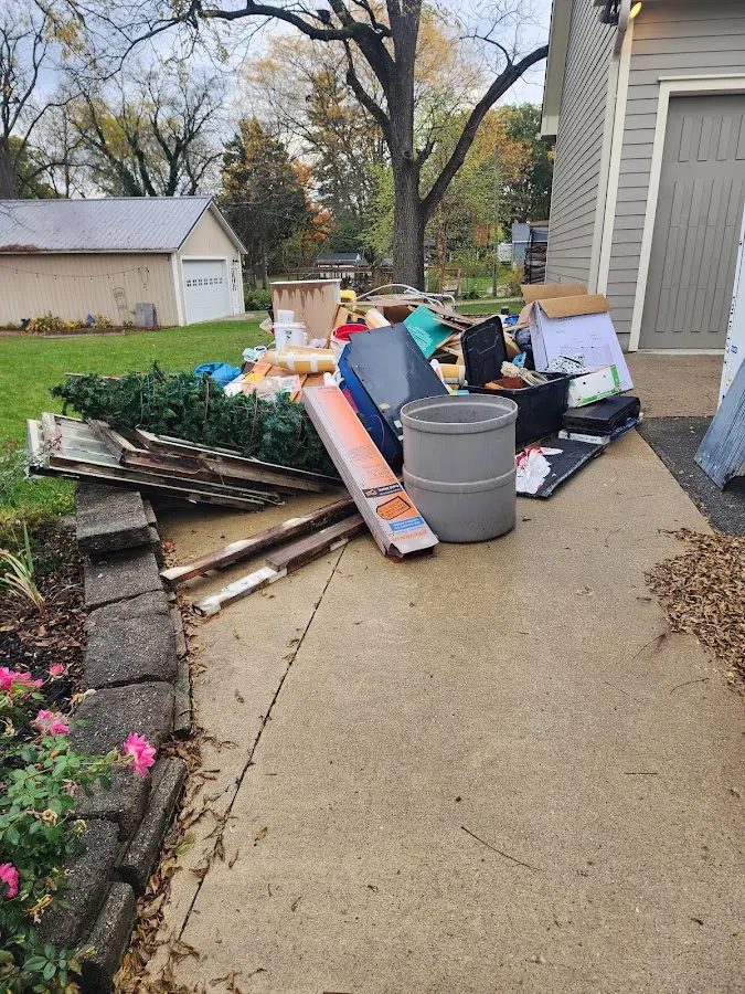 Dumpster being loaded with debris for 10 Yard Dumpster Rental in Maplewood